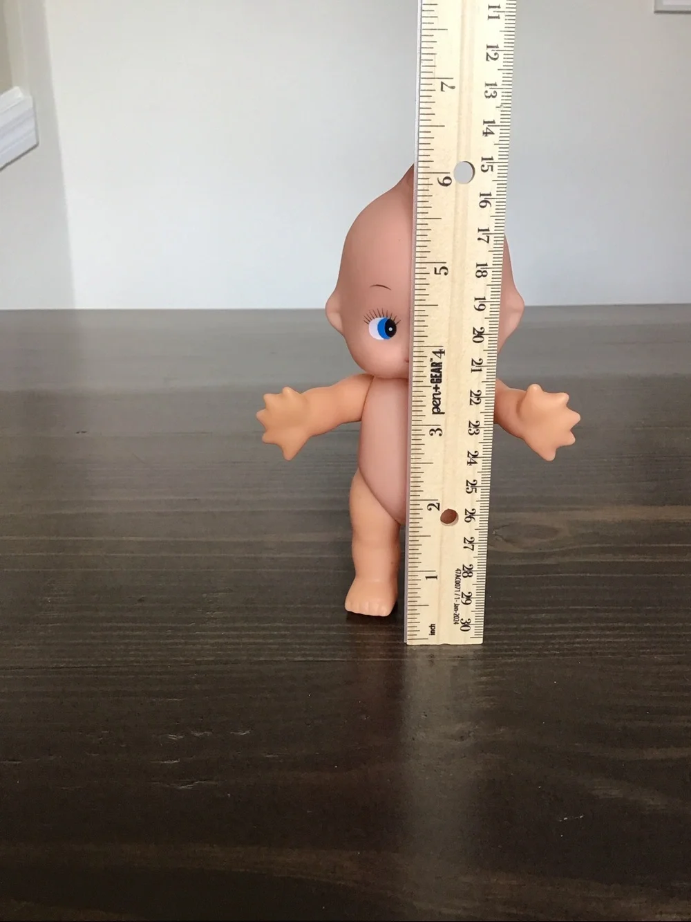Vintage unmarked 6-inch hard plastic Kewpie doll from the mid-century era